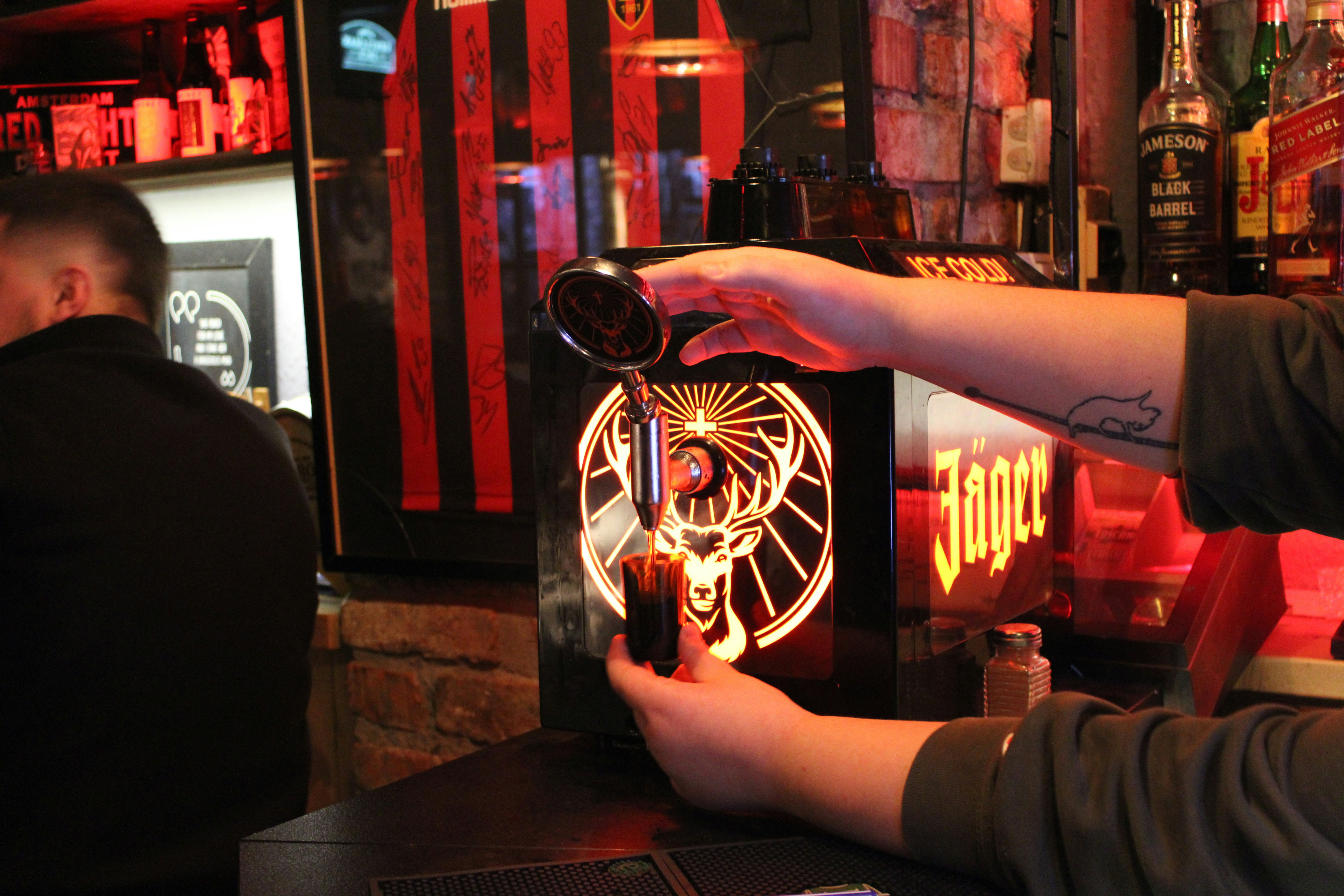 A man pouring a beer at a bar, Rock On