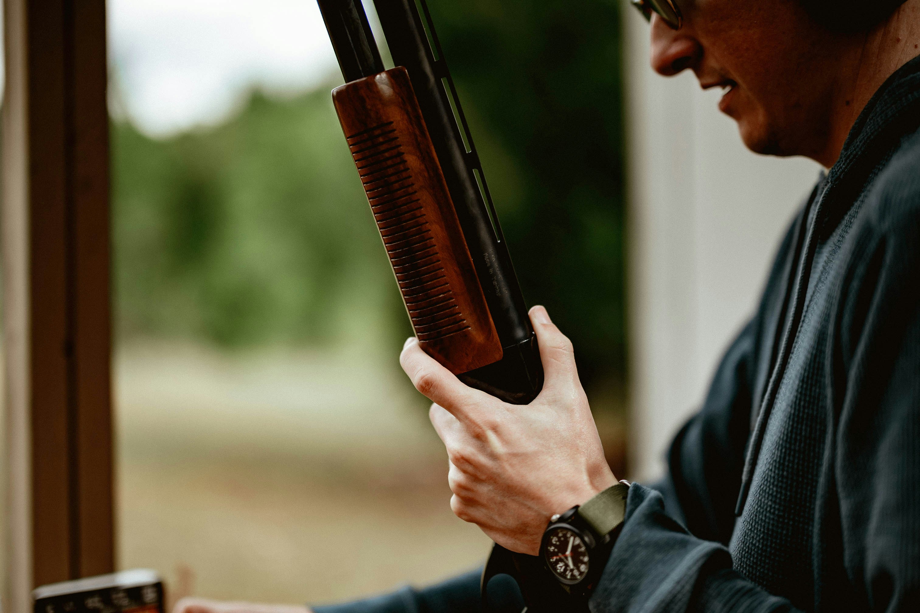 A man holding a gun in his right hand