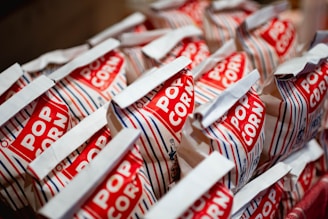 A bunch of red and white bags of popcorn