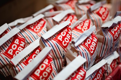 A bunch of red and white bags of popcorn