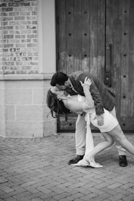A man and a woman kissing on the street