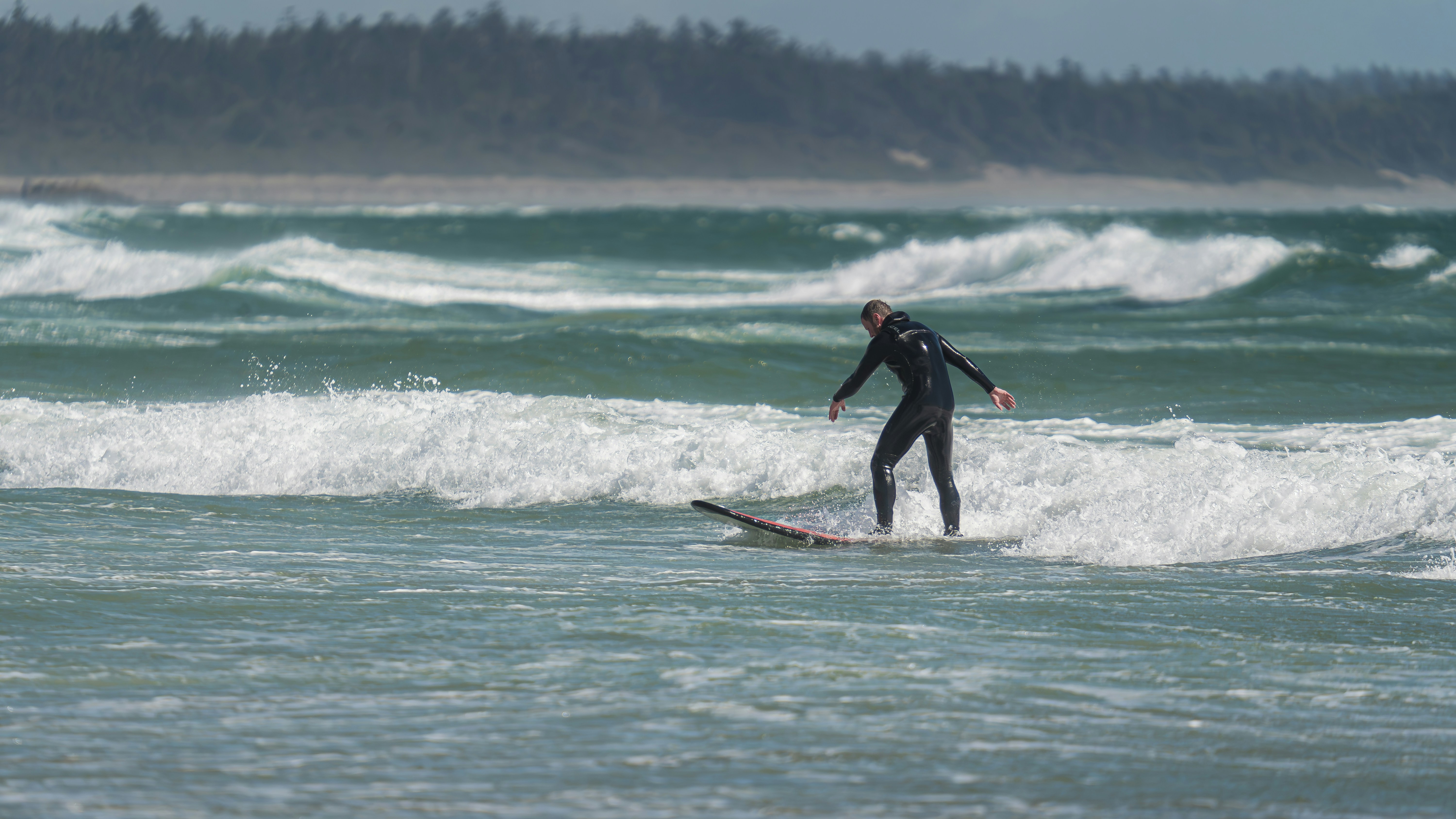 A man riding a surfboard on top of a wave in the ocean