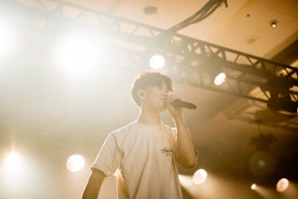 A man standing on a stage holding a microphone