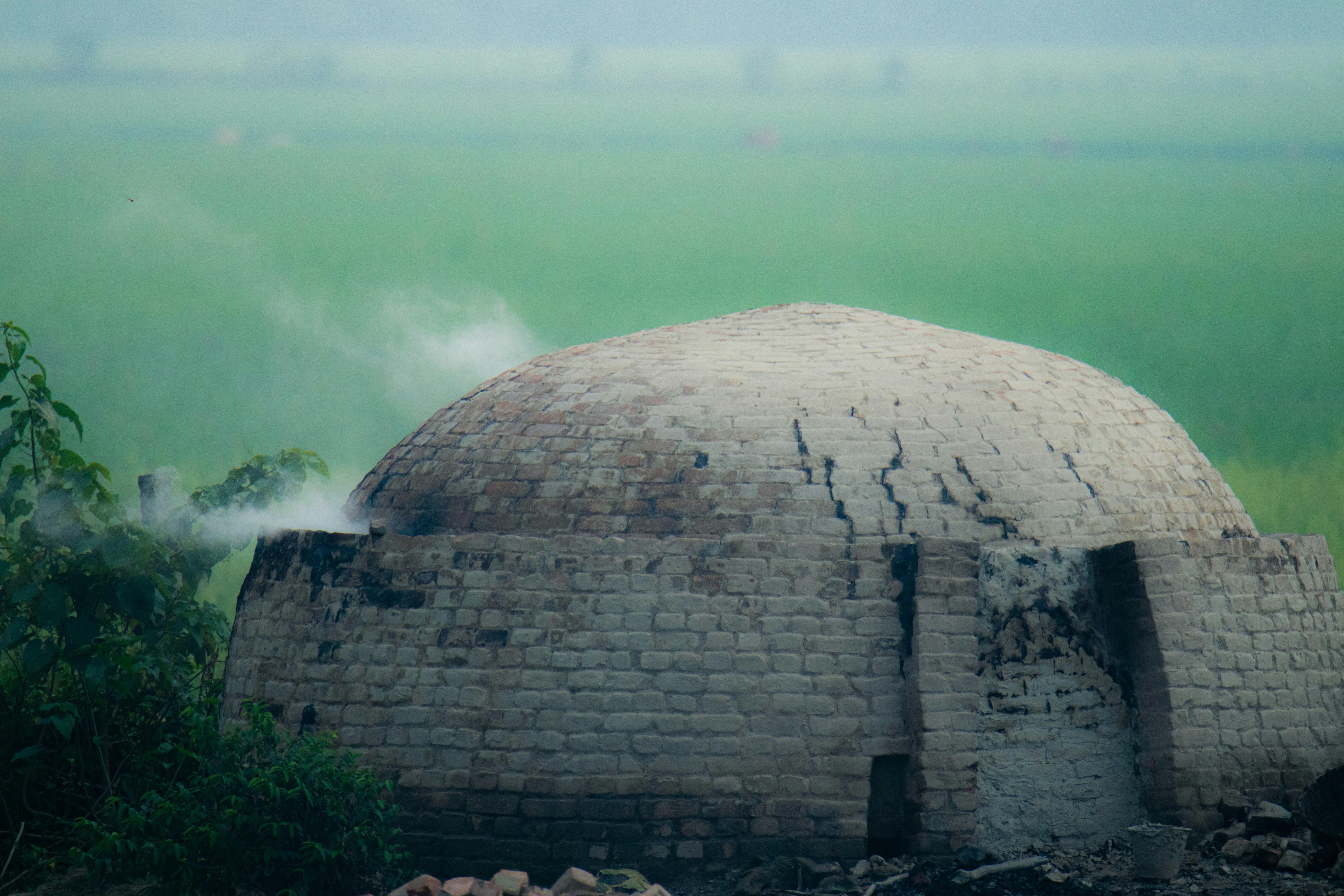 A stone structure in the middle of a field