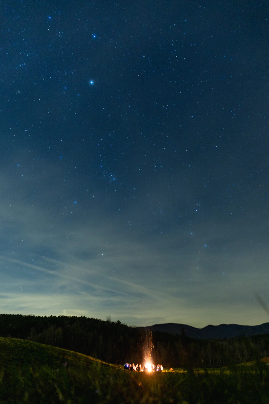Campfire under a starlit sky