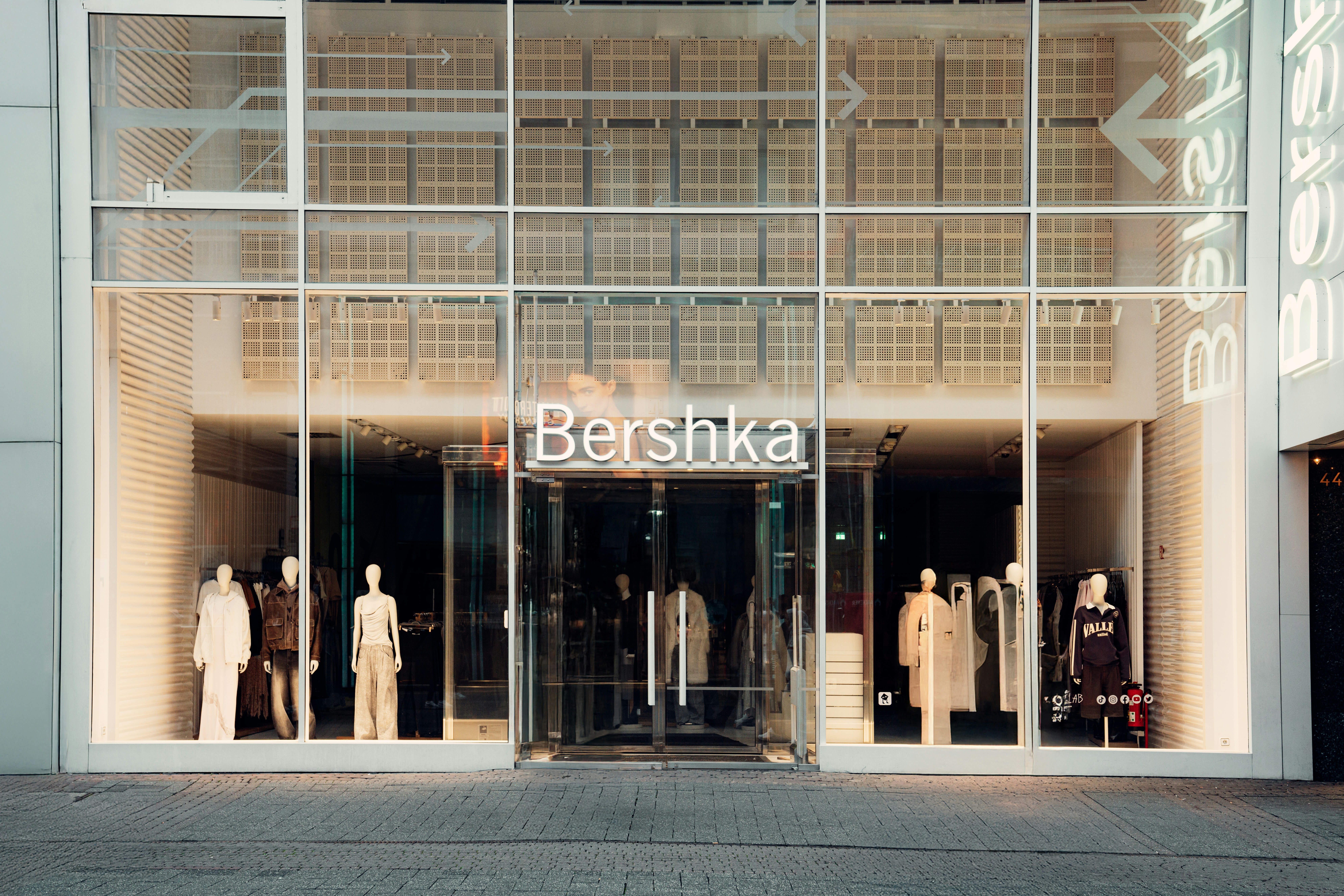 A store front with a large glass window and mannequins