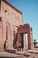 A couple of people standing in front of a building