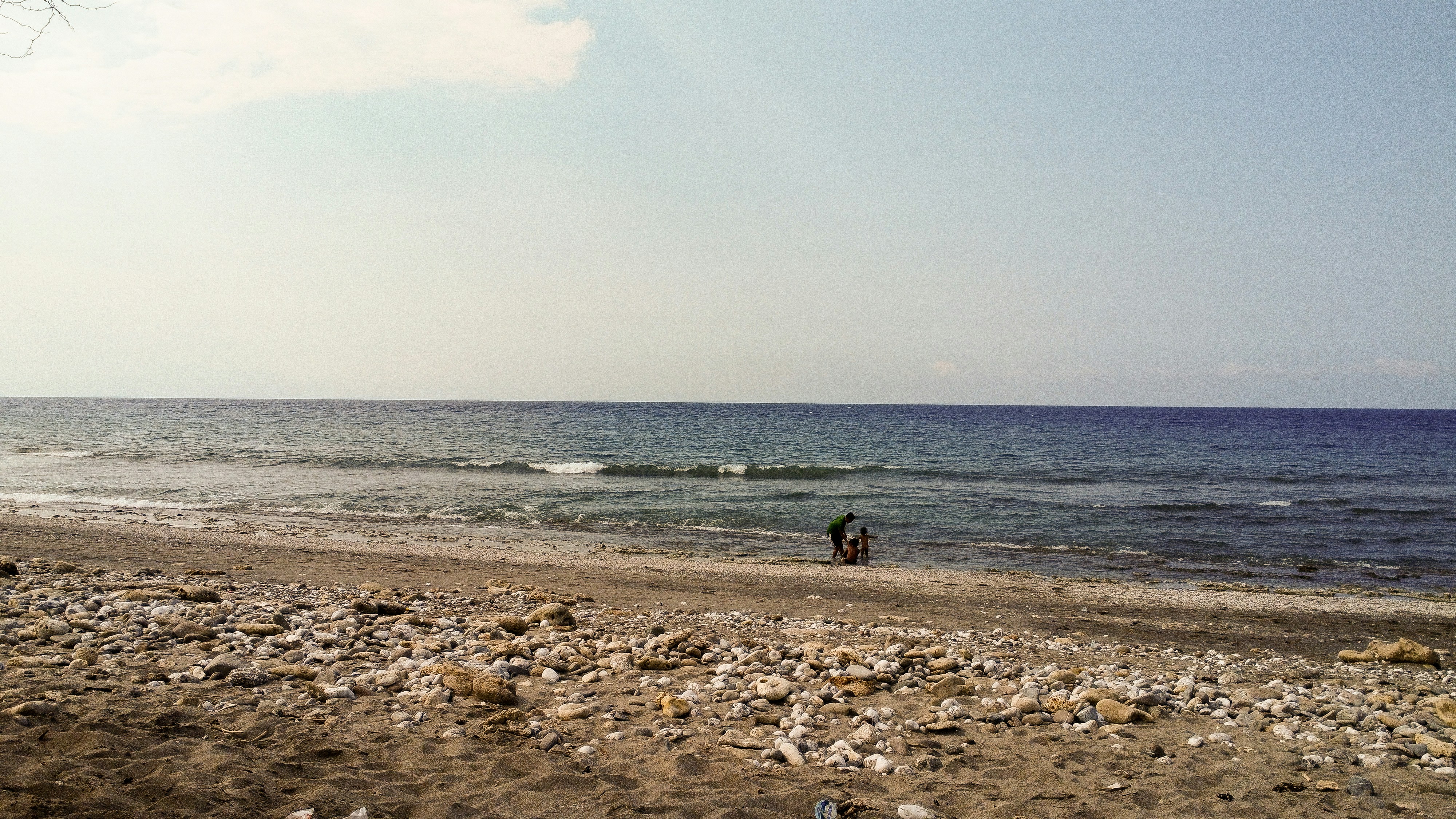 A person walking on a beach near the ocean