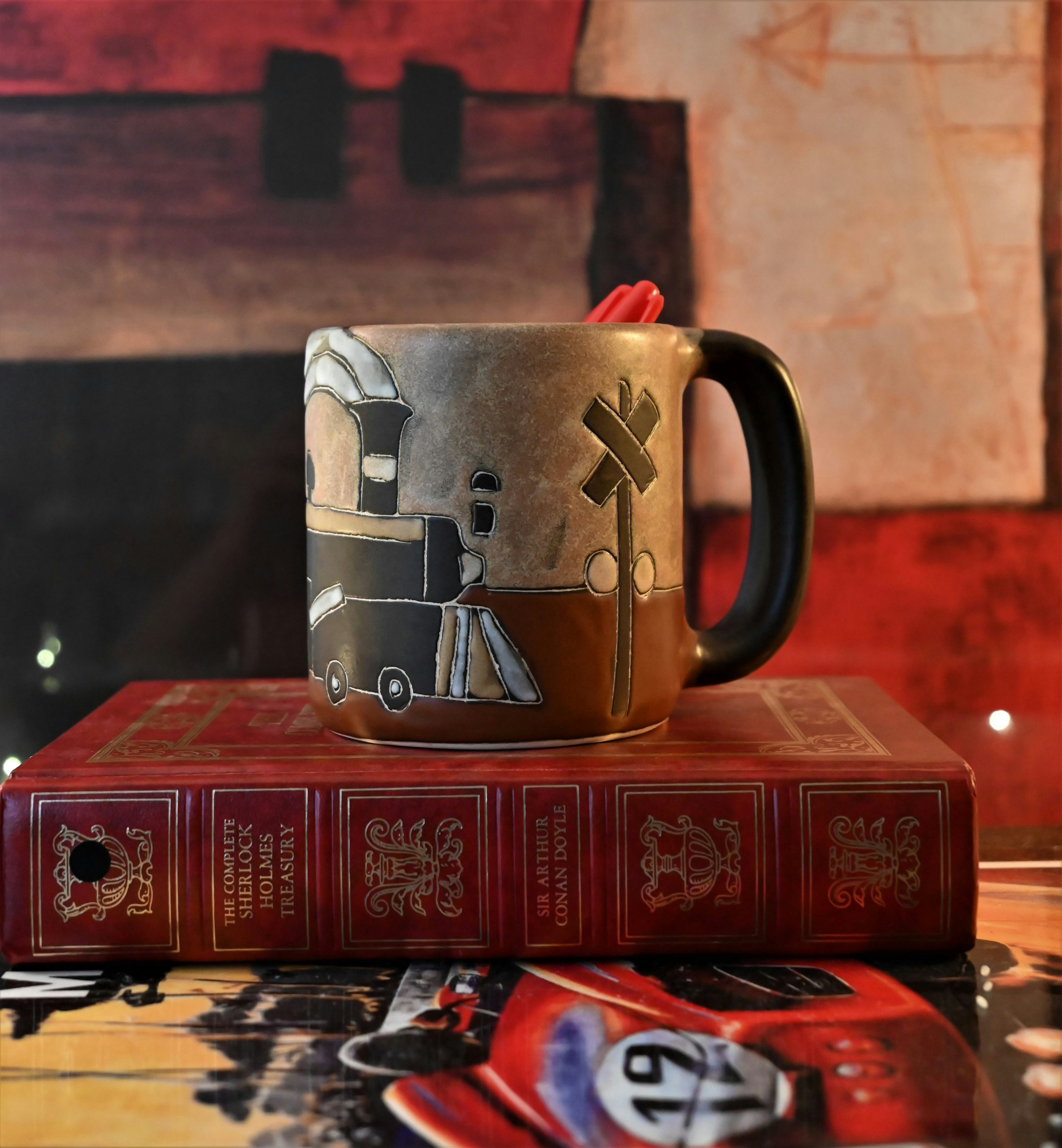 A coffee mug sitting on top of a stack of books