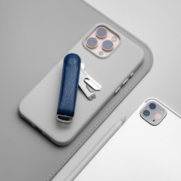 A cell phone with a blue case and a silver case
