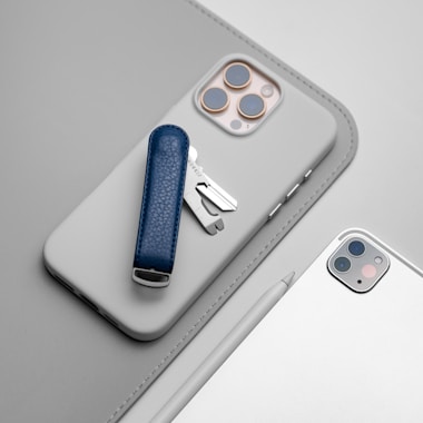 A cell phone with a blue case and a silver case