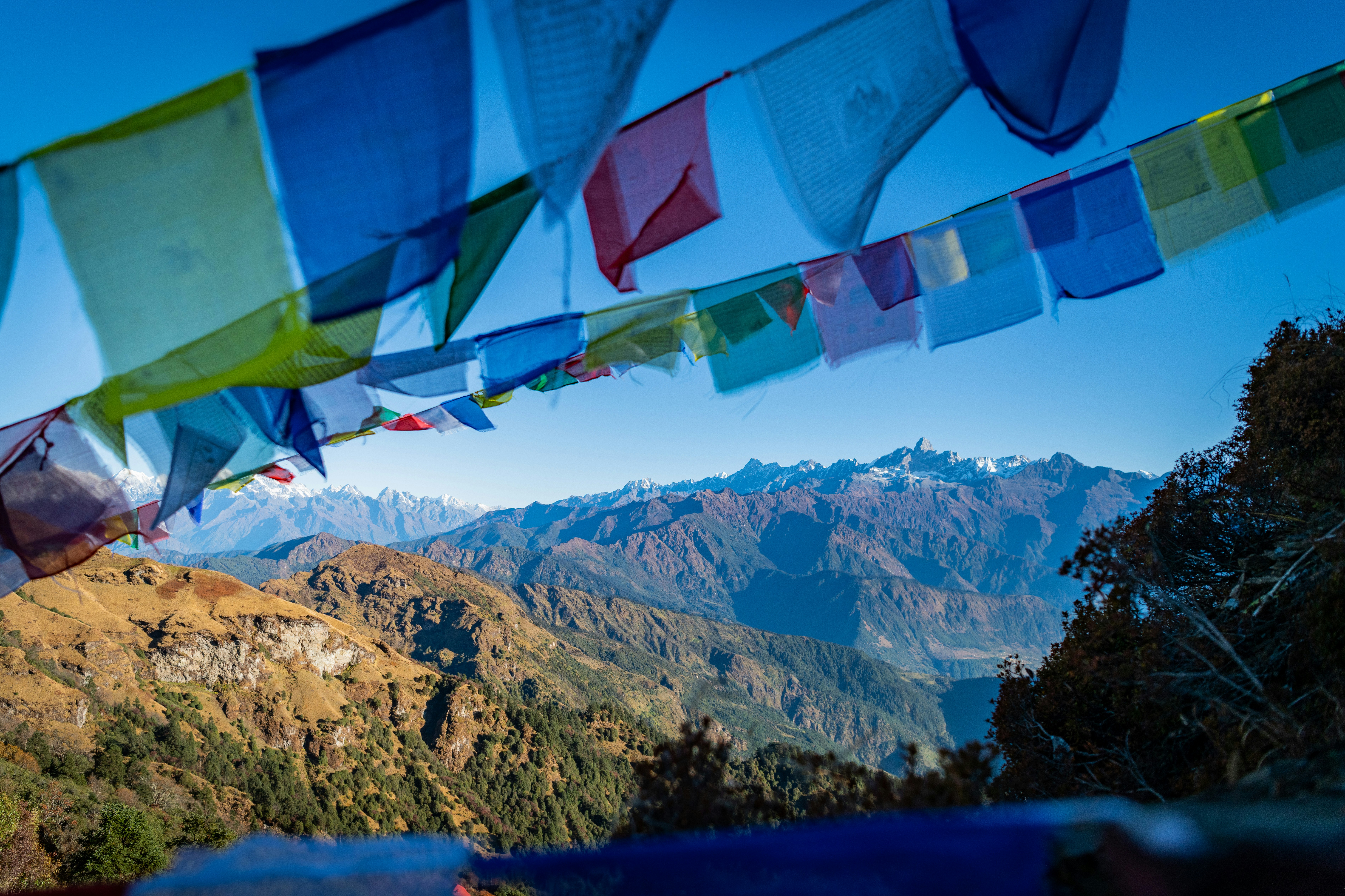A group of colorful flags hanging from the side of a mountain