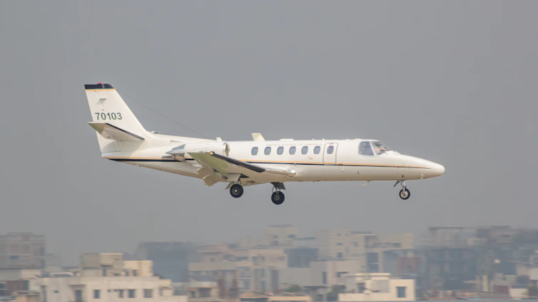 A small plane flying low over a city