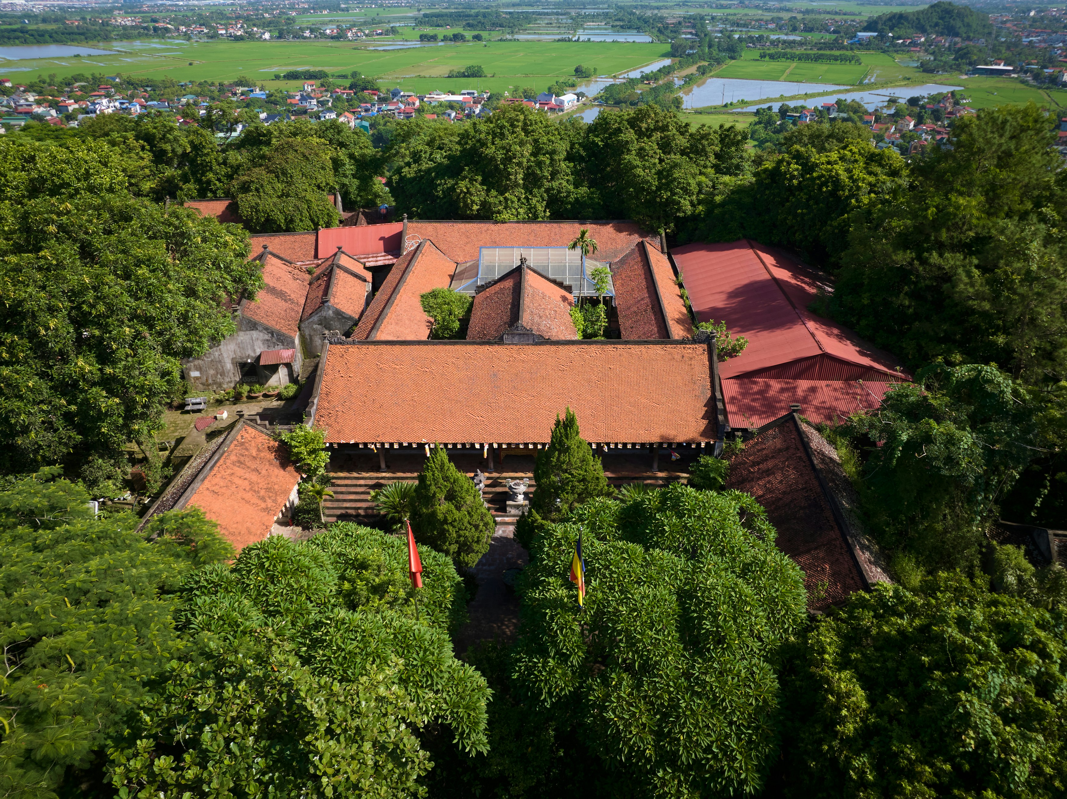 An aerial view of a building surrounded by trees