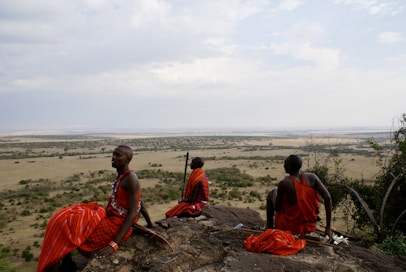 A group of people sitting on top of a rock