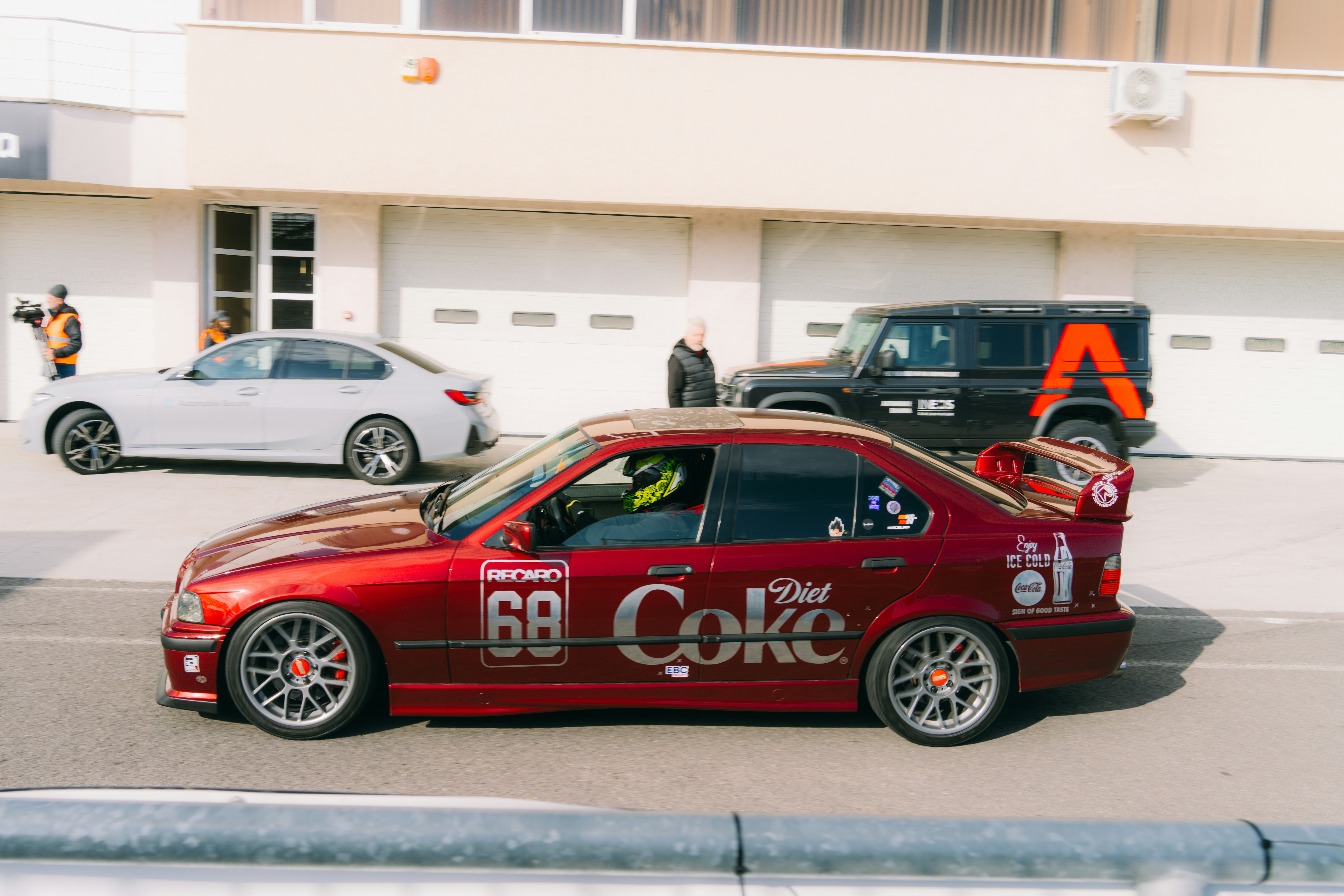 A red car parked in front of a building