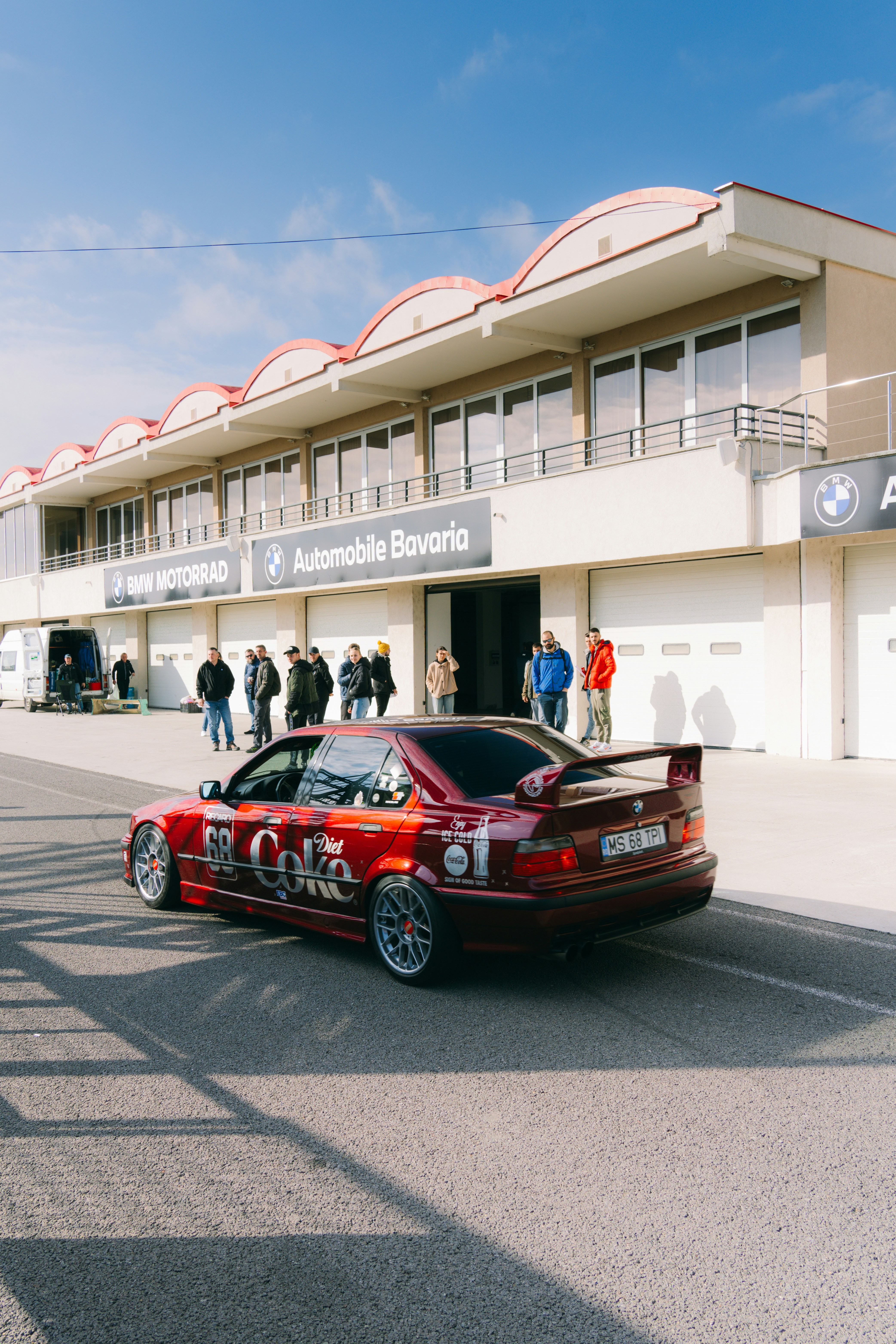 A red car parked in front of a building