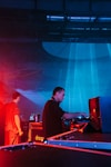 A dj mixing music on a stage at a concert