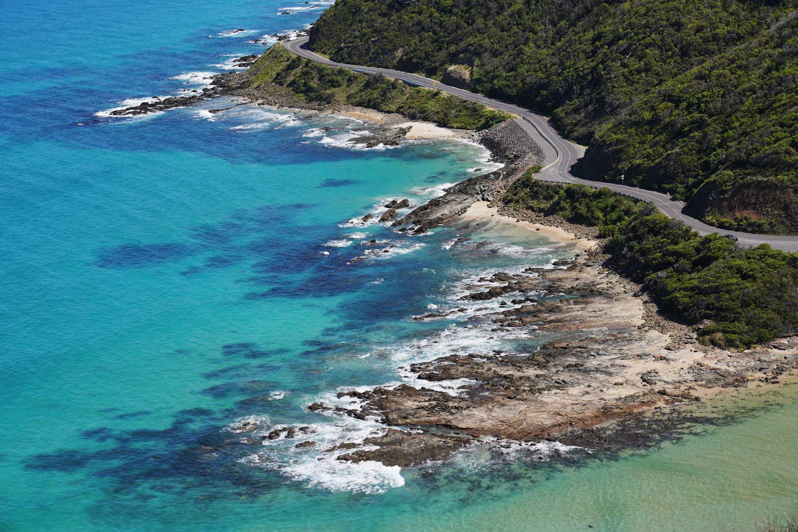 An aerial view of the Great Ocean Road beside the beach