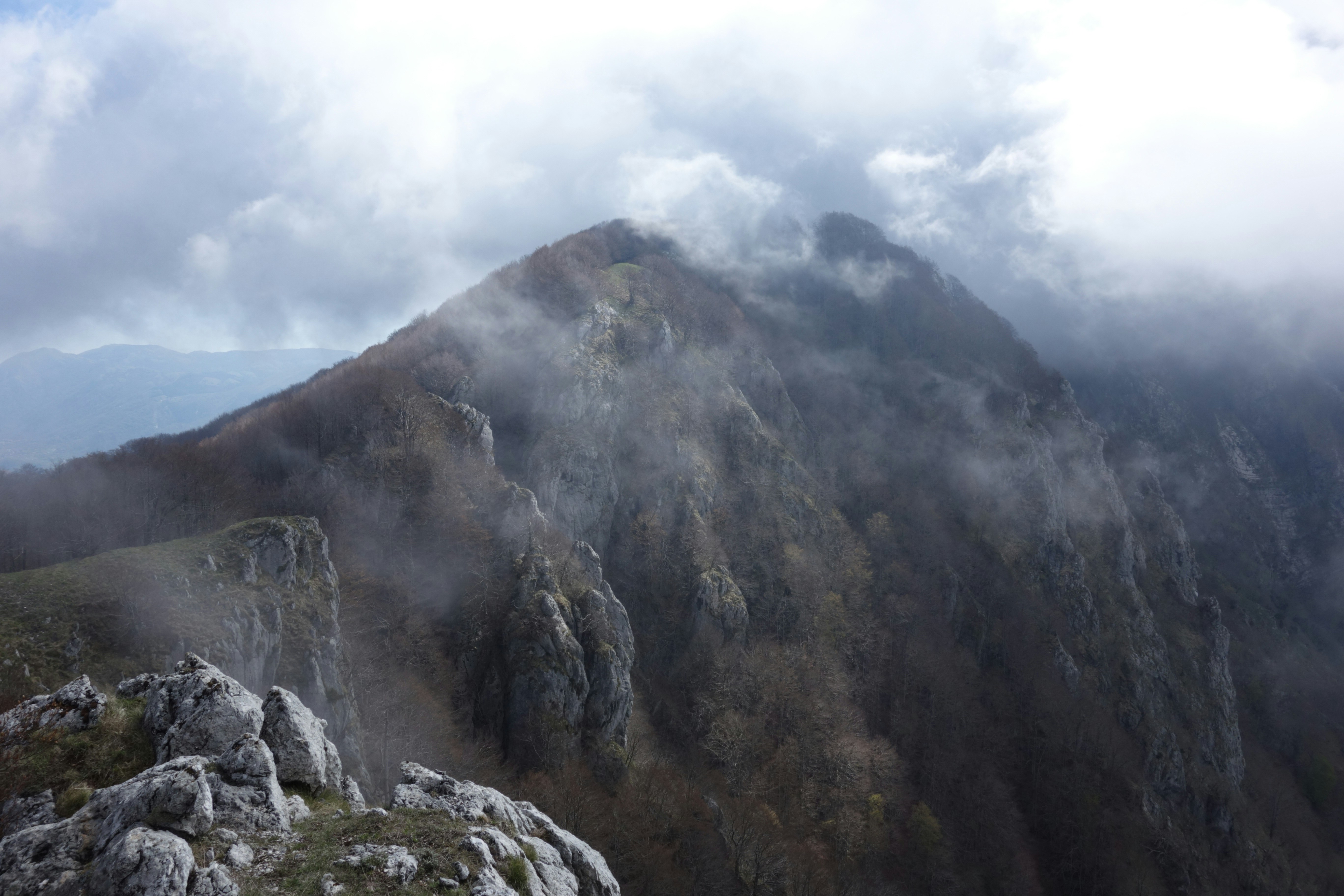 Una persona in piedi sulla cima di una montagna