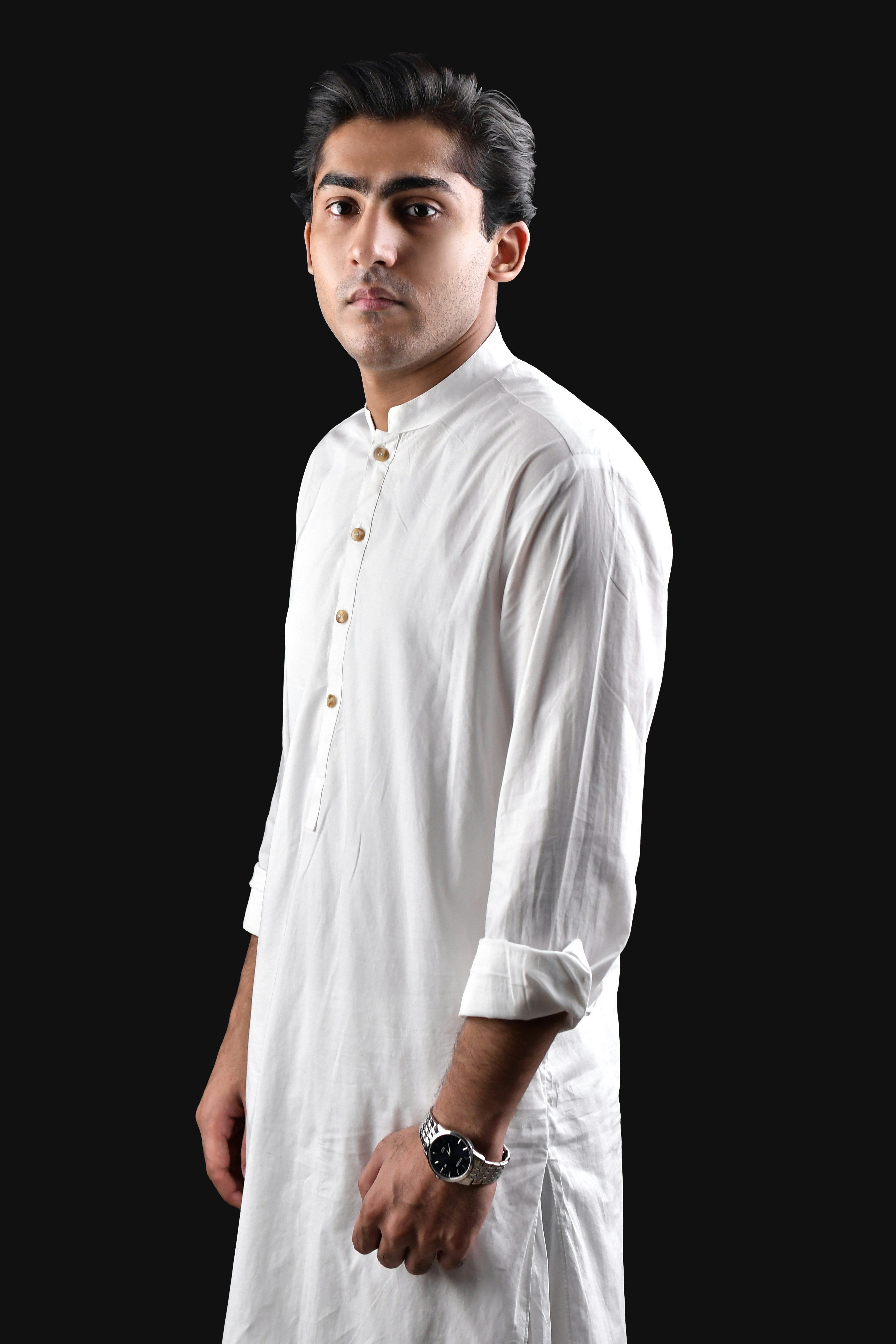 A man in a white shirt is posing for a picture