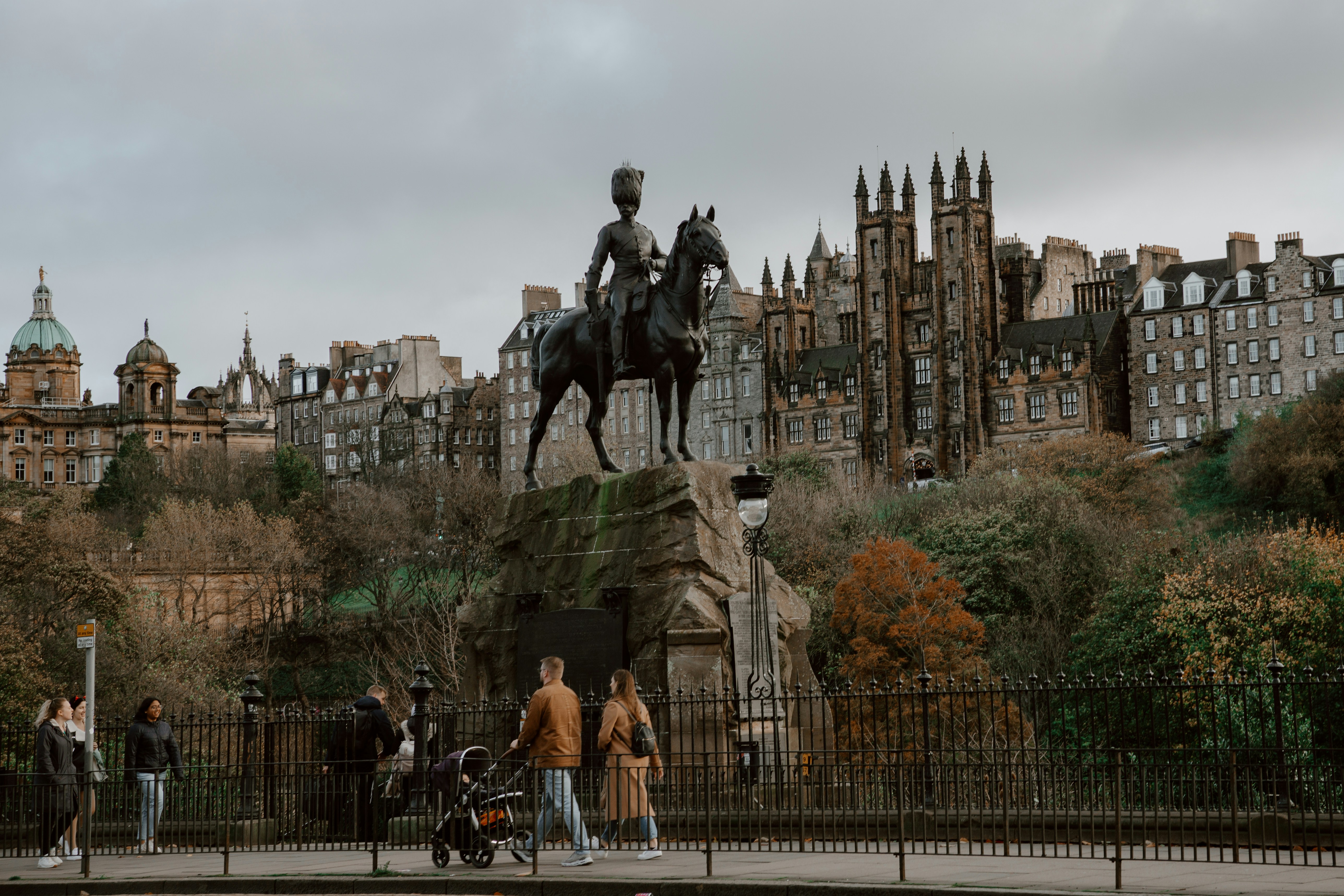 A statue of a man riding a horse on a bridge