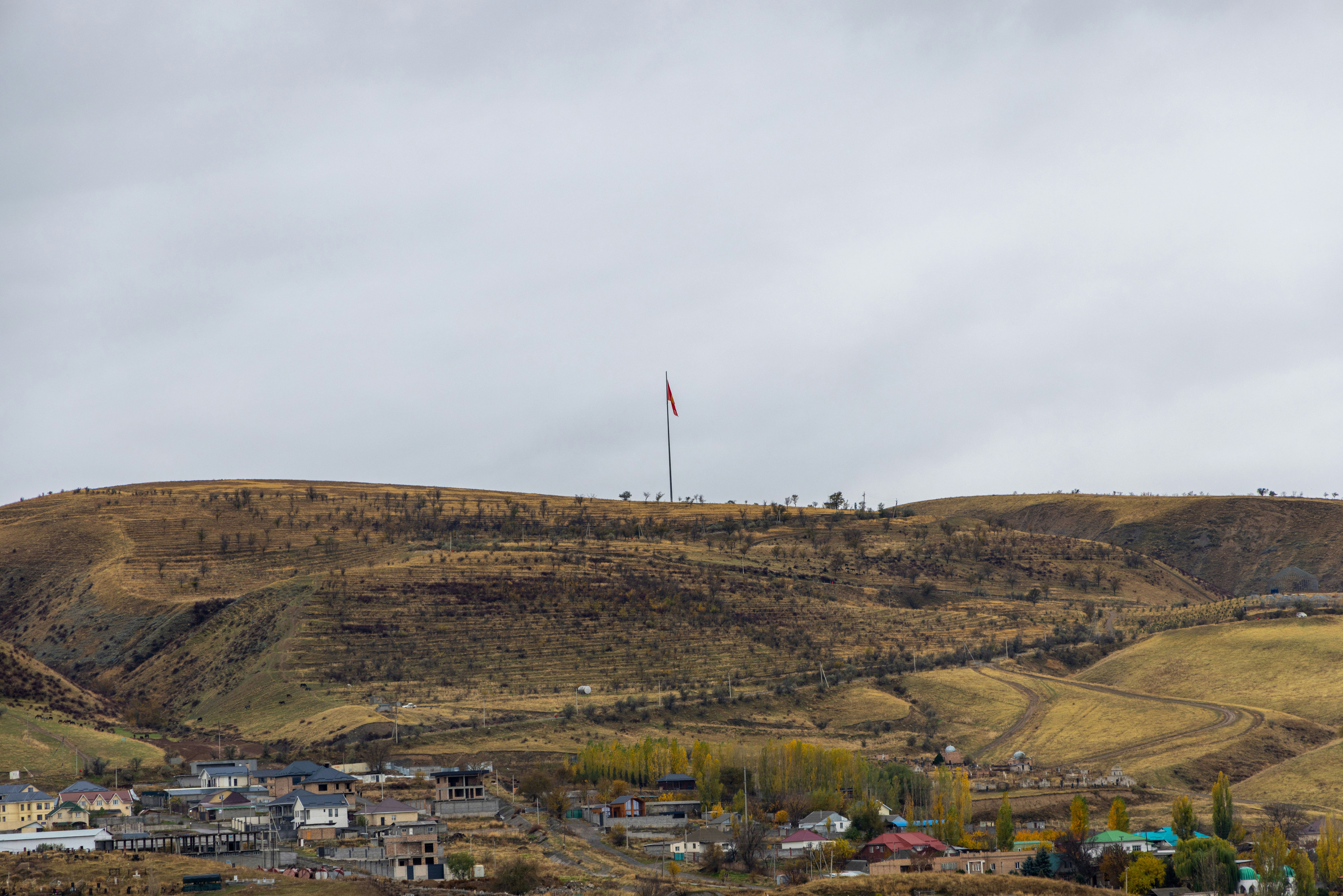 A small town on a hill with a hill in the background