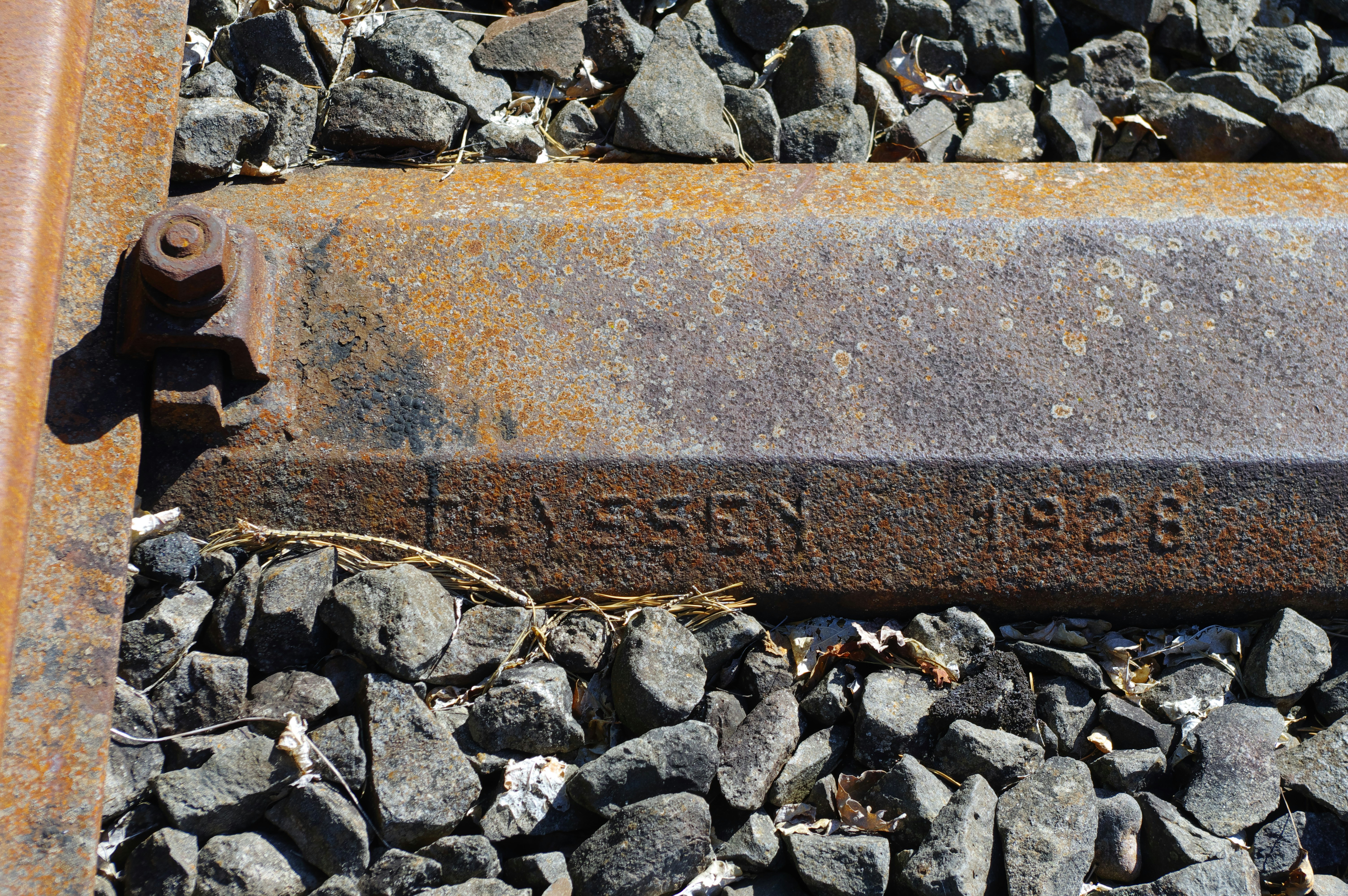 A close up of a train track with a marker on it