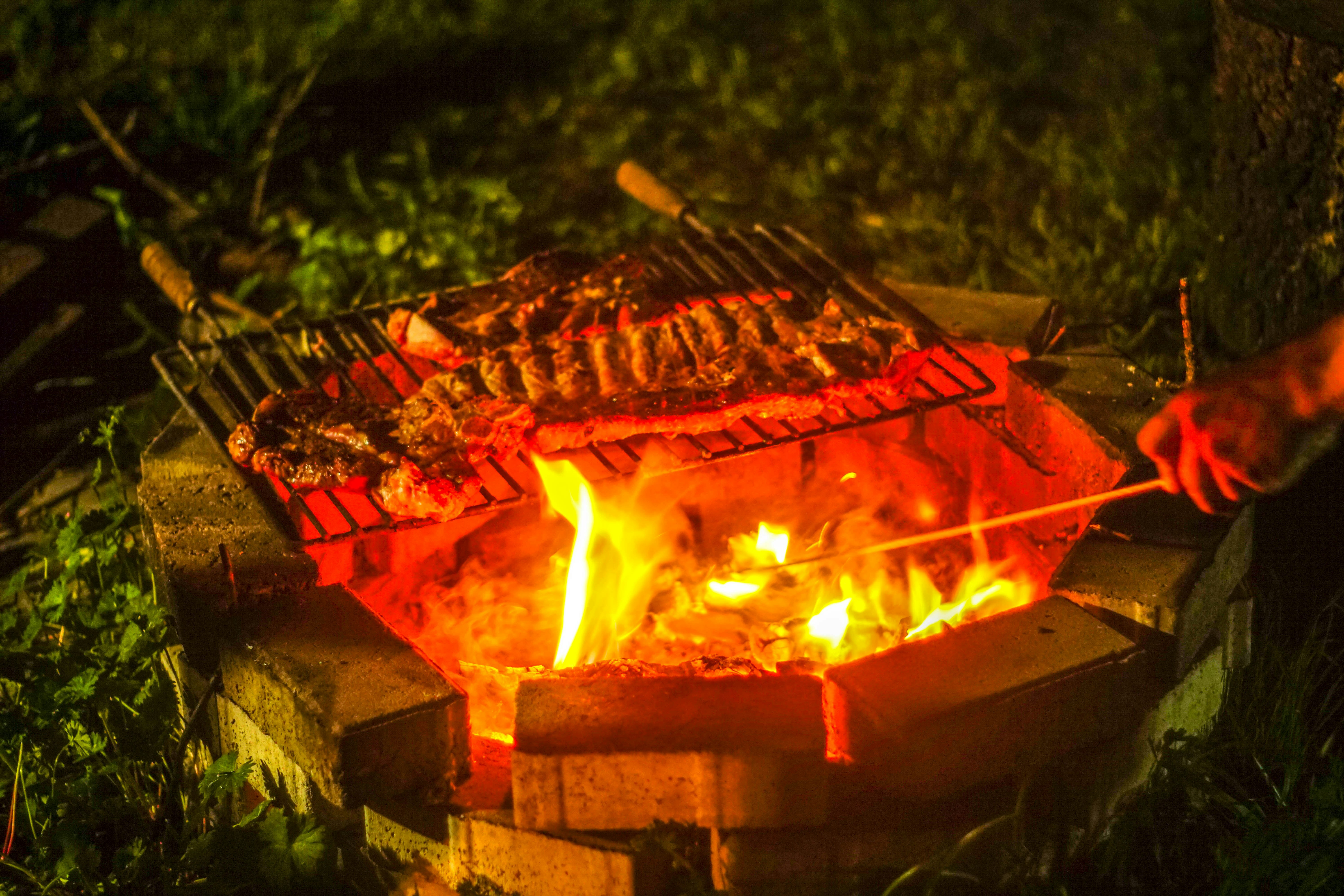 A bbq grill is lit up in the dark