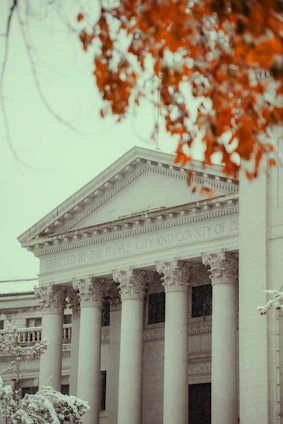 A white building with columns and a clock tower