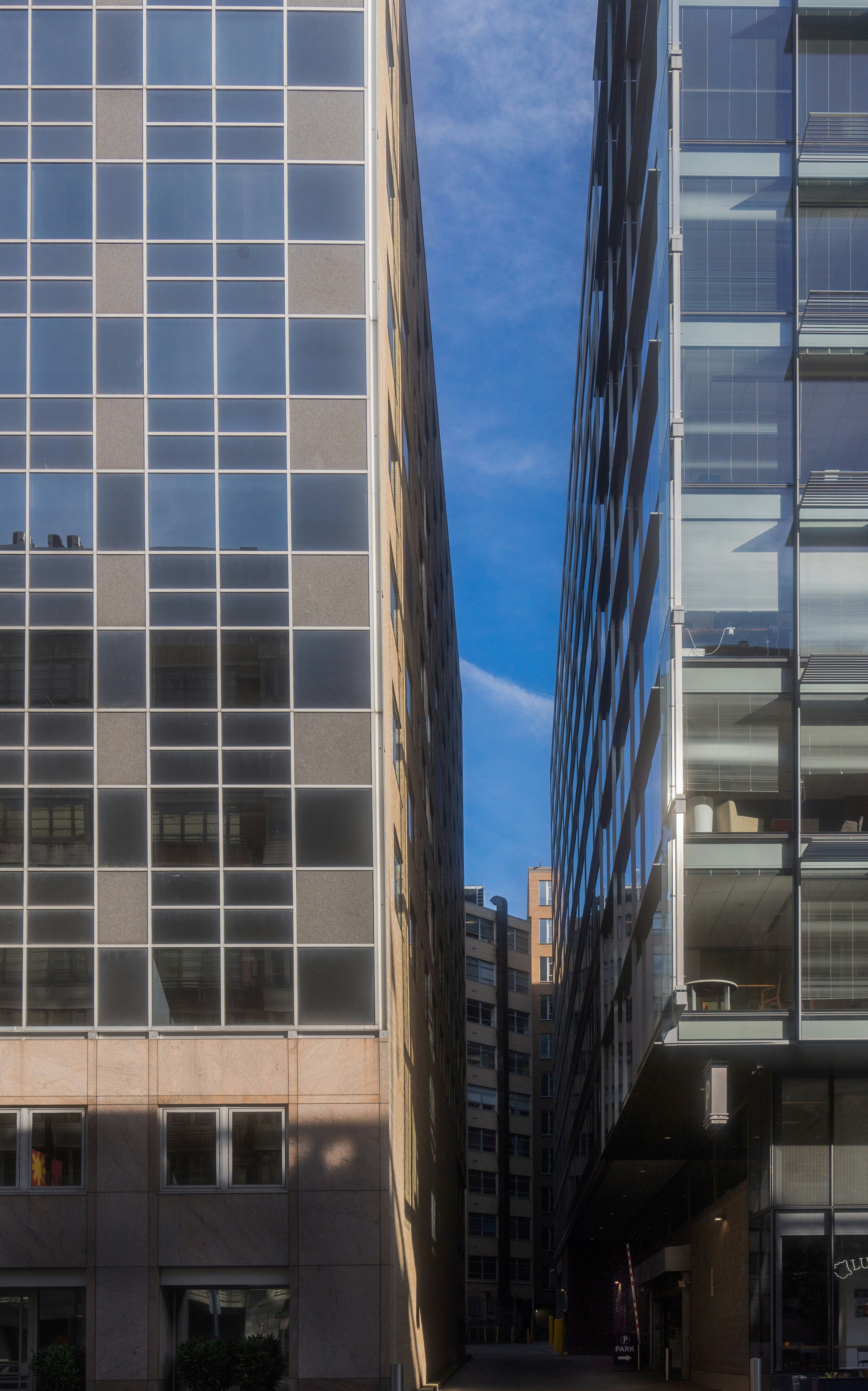 Bright modern government building exterior, clean architecture, clear blue sky