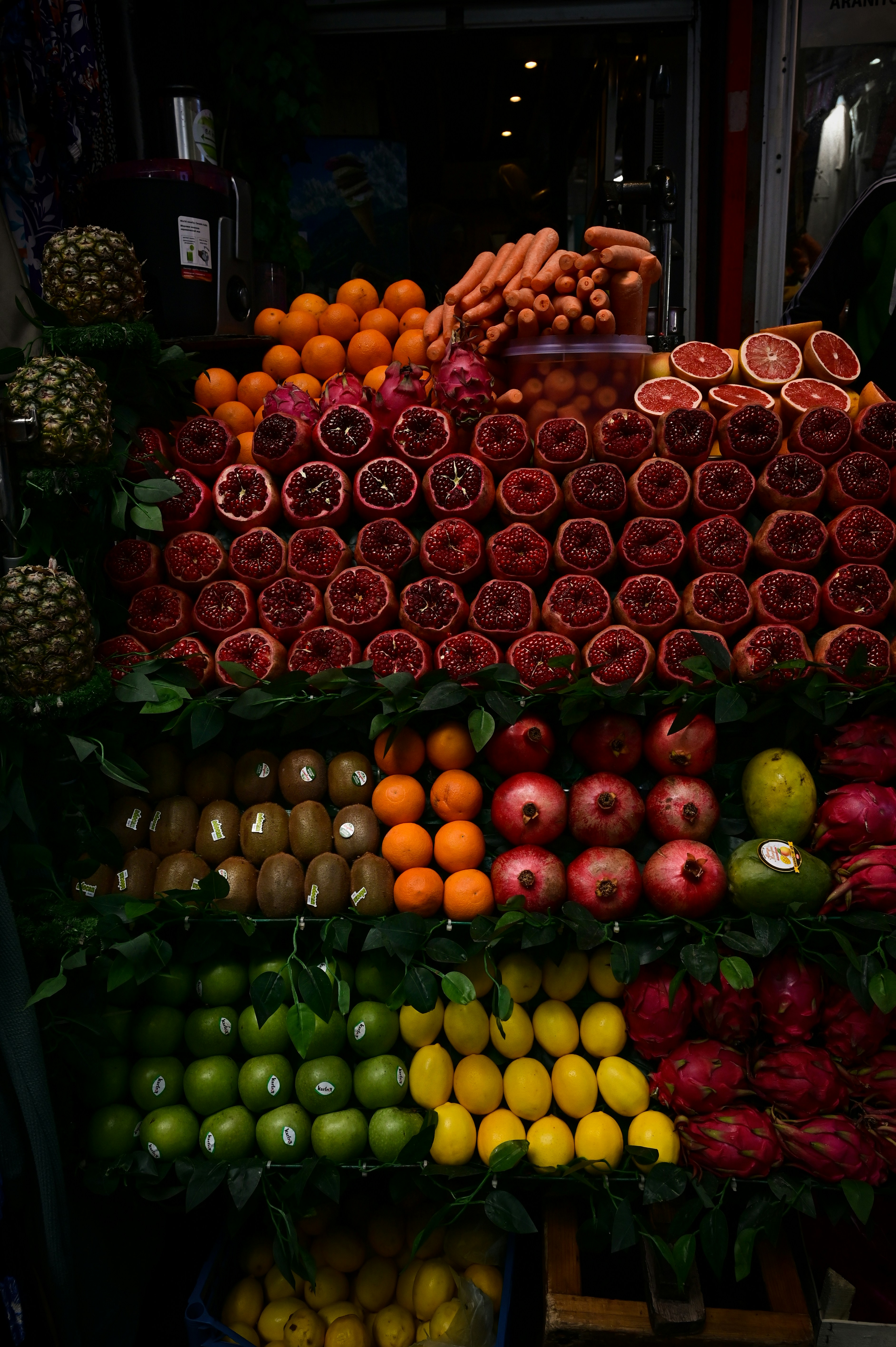 A man standing in front of a display of fruits