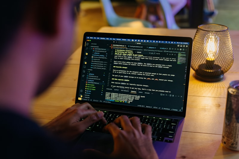 Person sitting at a table with a laptop