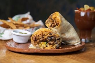 A burrito sitting on top of a wooden plate