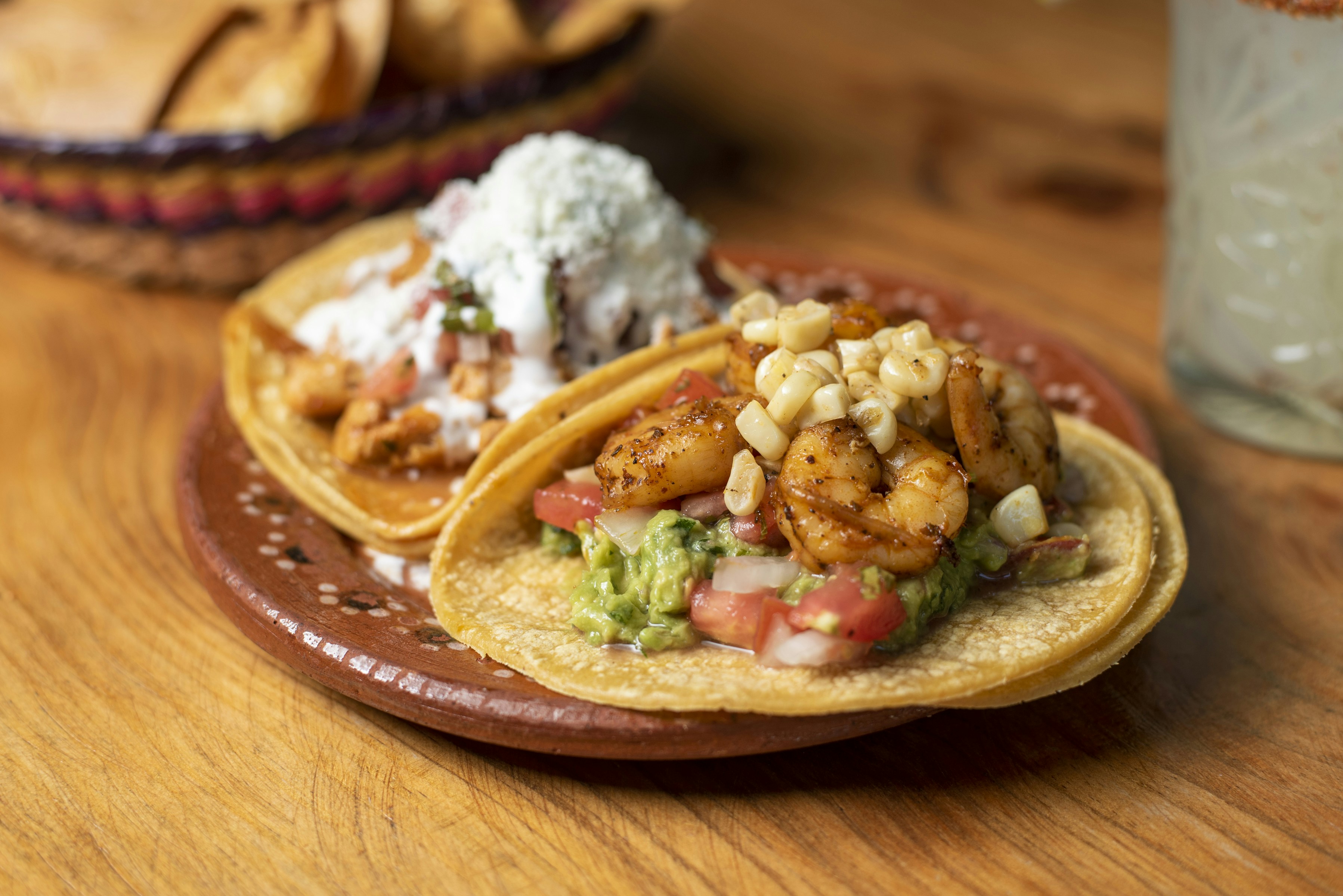 A couple of tacos sitting on top of a wooden table
