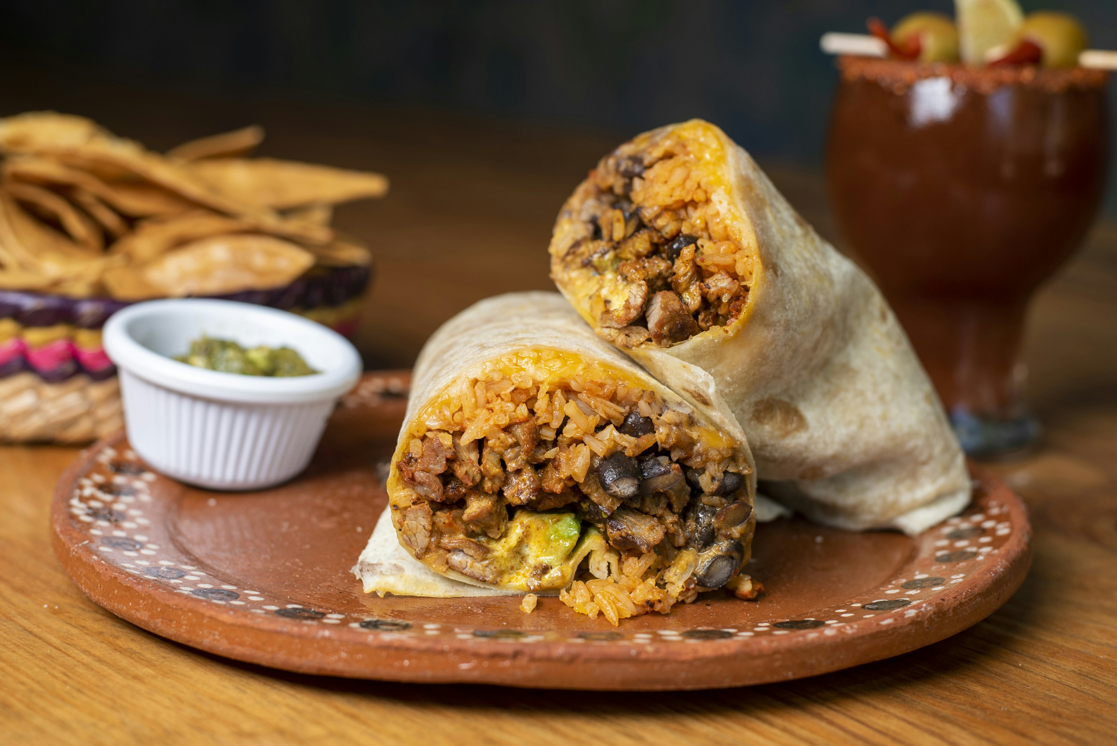 A burrito cut in half on a plate