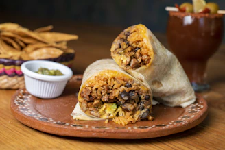 A burrito cut in half on a plate