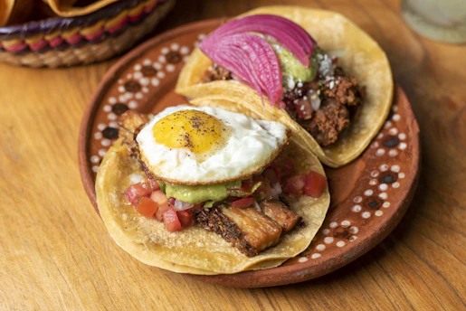 Two tacos on a plate on a wooden table