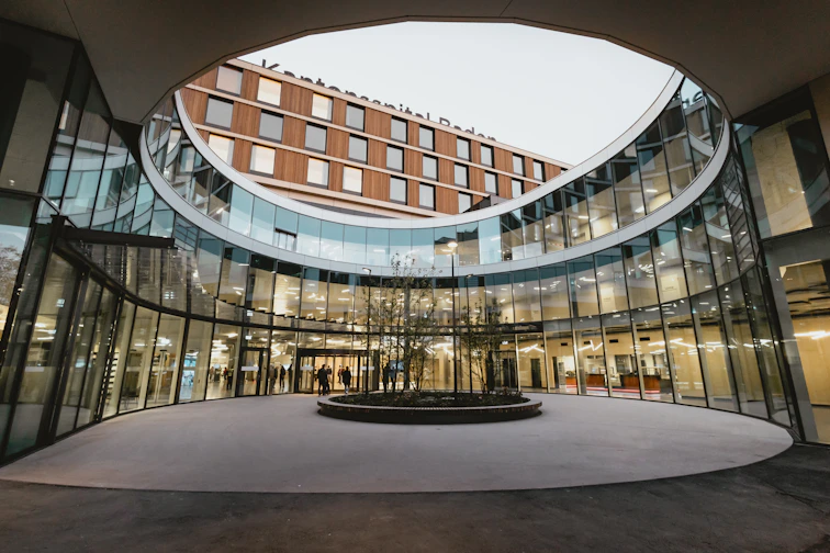 A circular building with a fountain in the middle of it