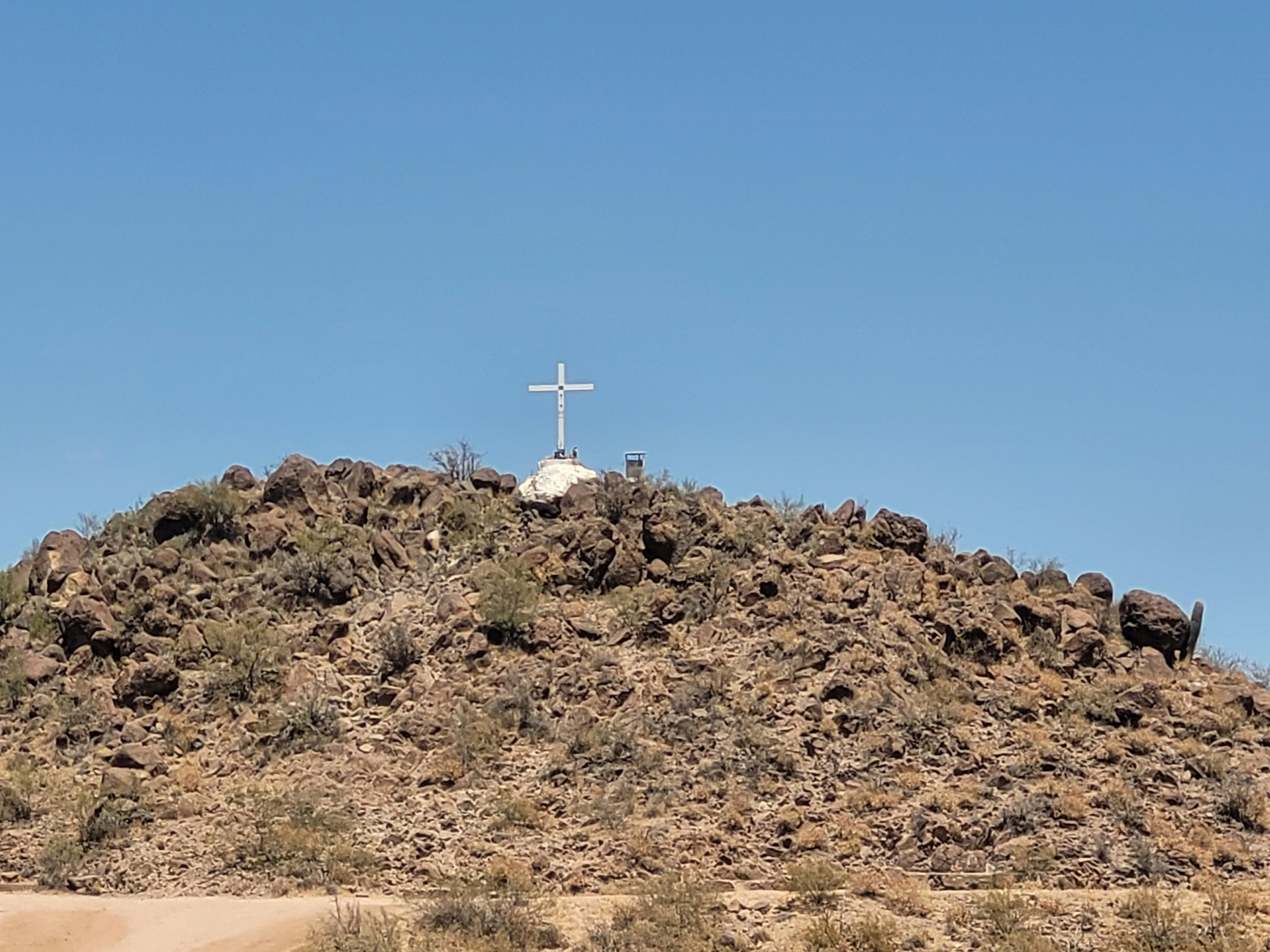 A hill with a cross on top of it