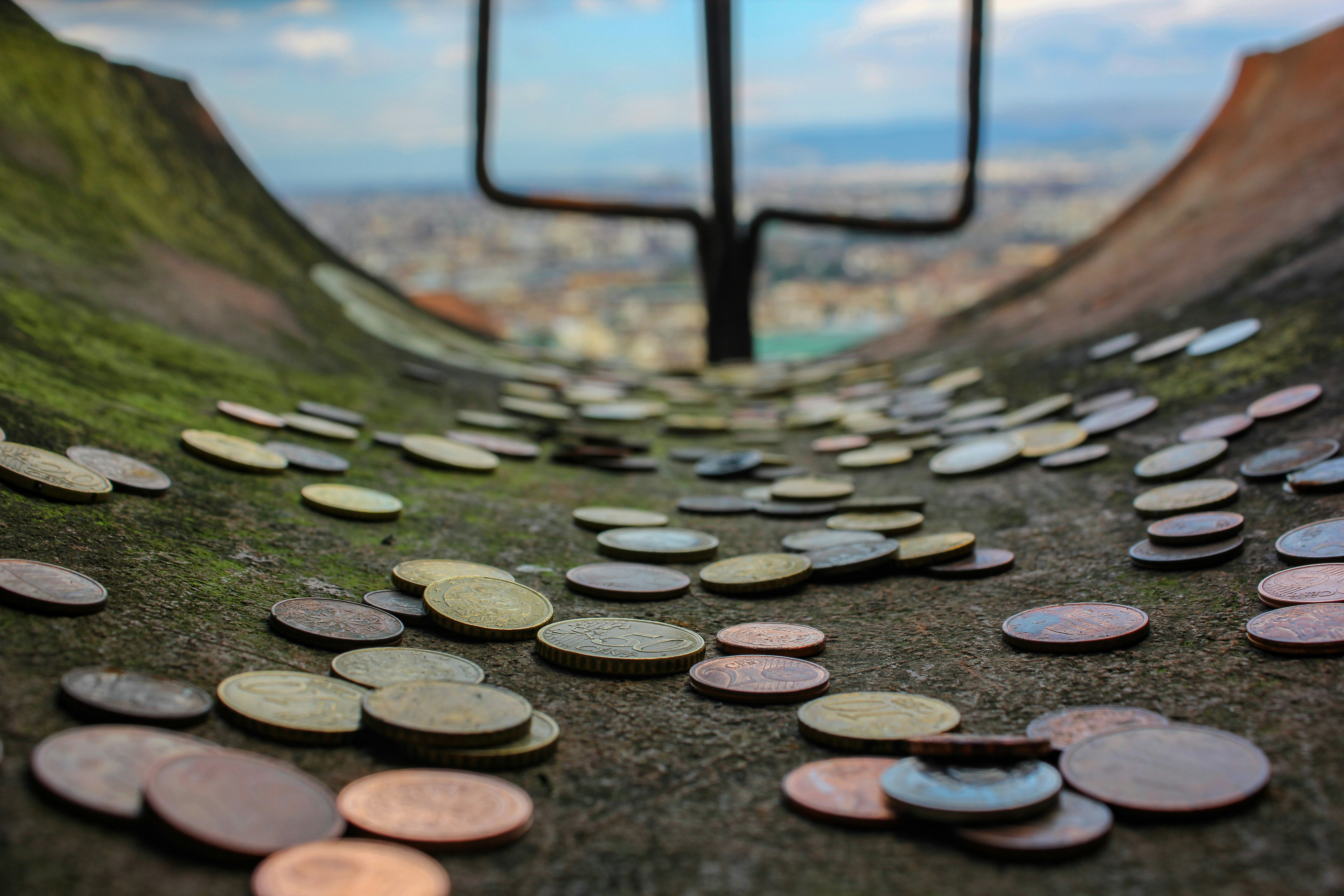 A bunch of coins sitting on top of a hill