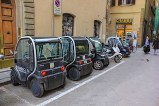 A row of cars parked on the side of a street