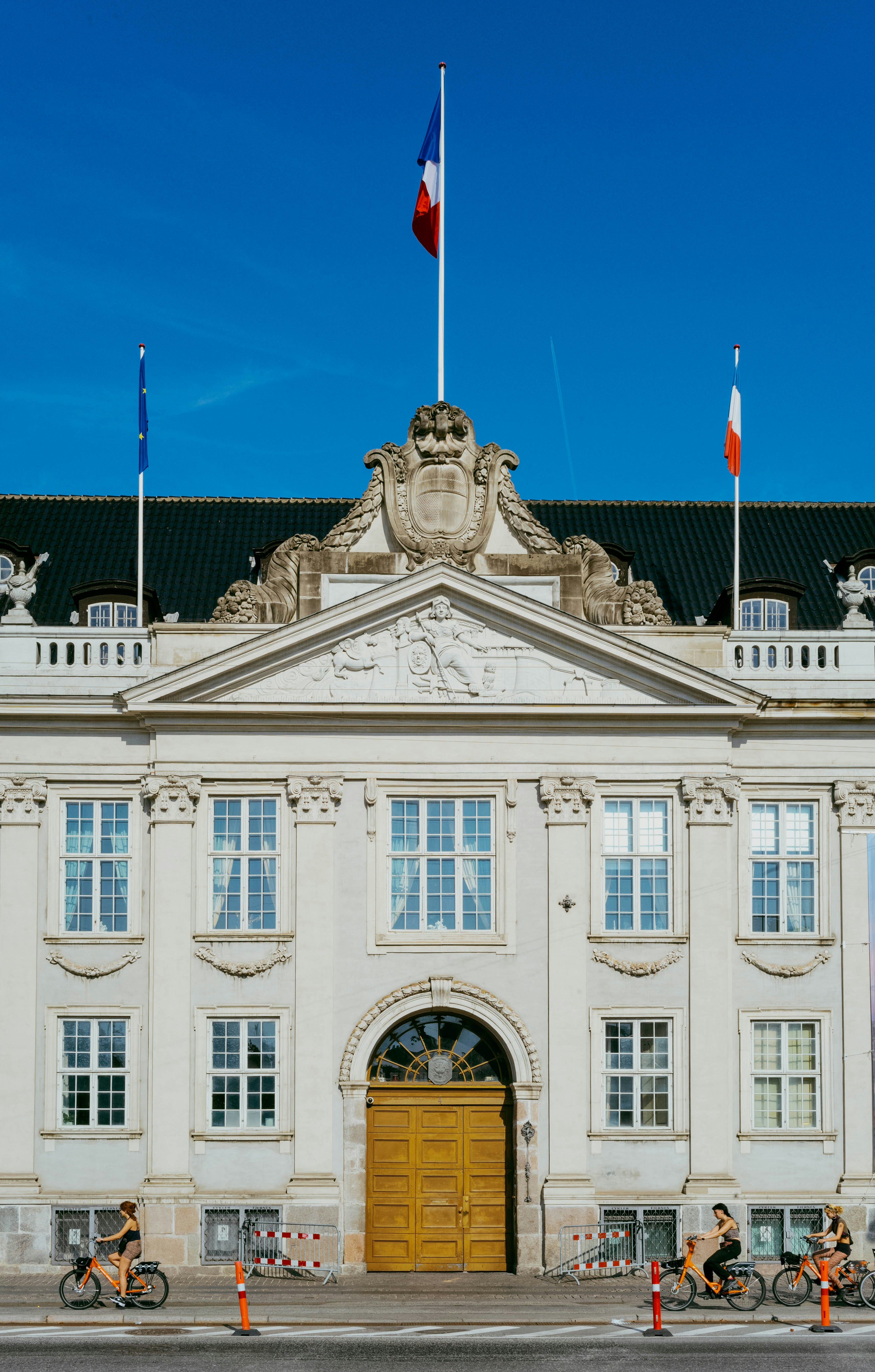 A large white building with a flag on top of it photo – Free Building ...