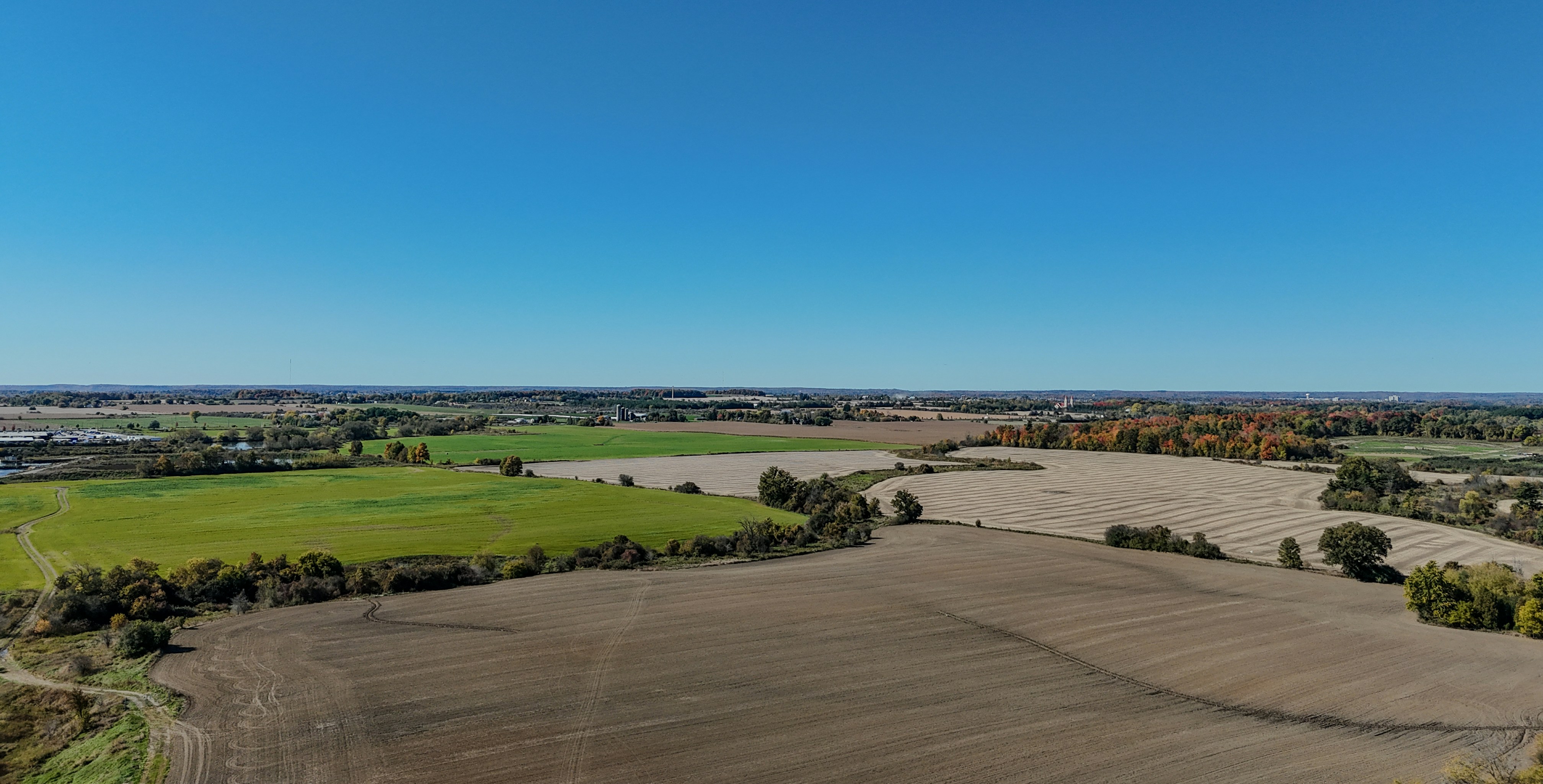 An aerial view of a large field with trees