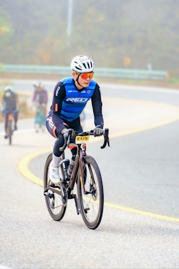 A man riding a bike down a curvy road