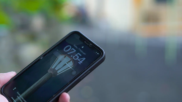 A person holding a cell phone in their hand