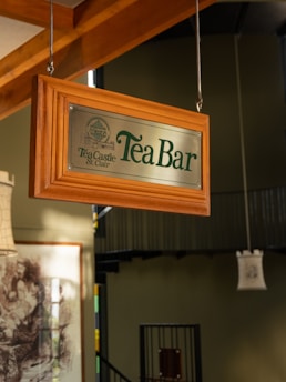 A sign hanging from the ceiling of a restaurant