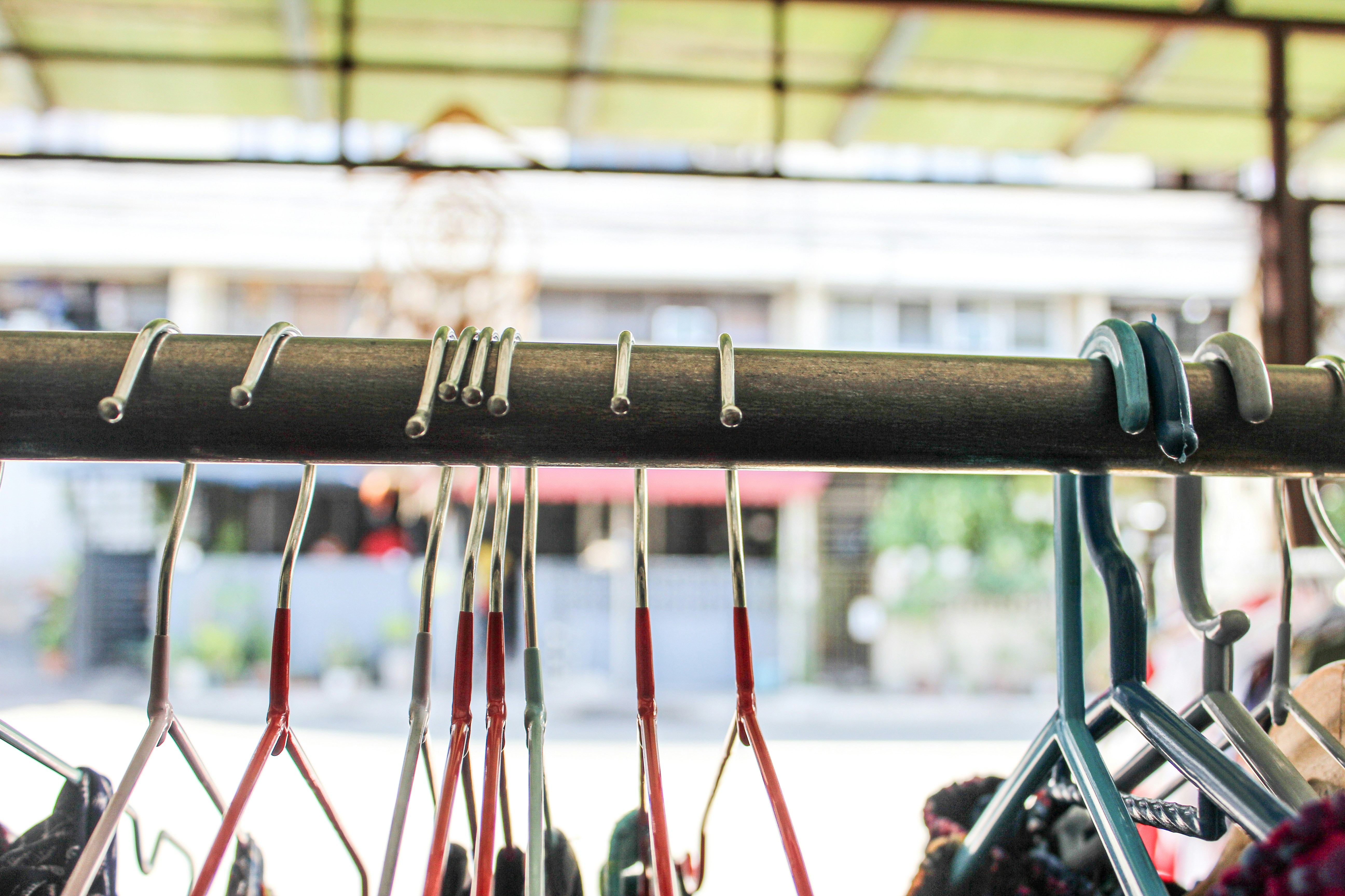 A rack of various pairs of shoes hanging from a ceiling