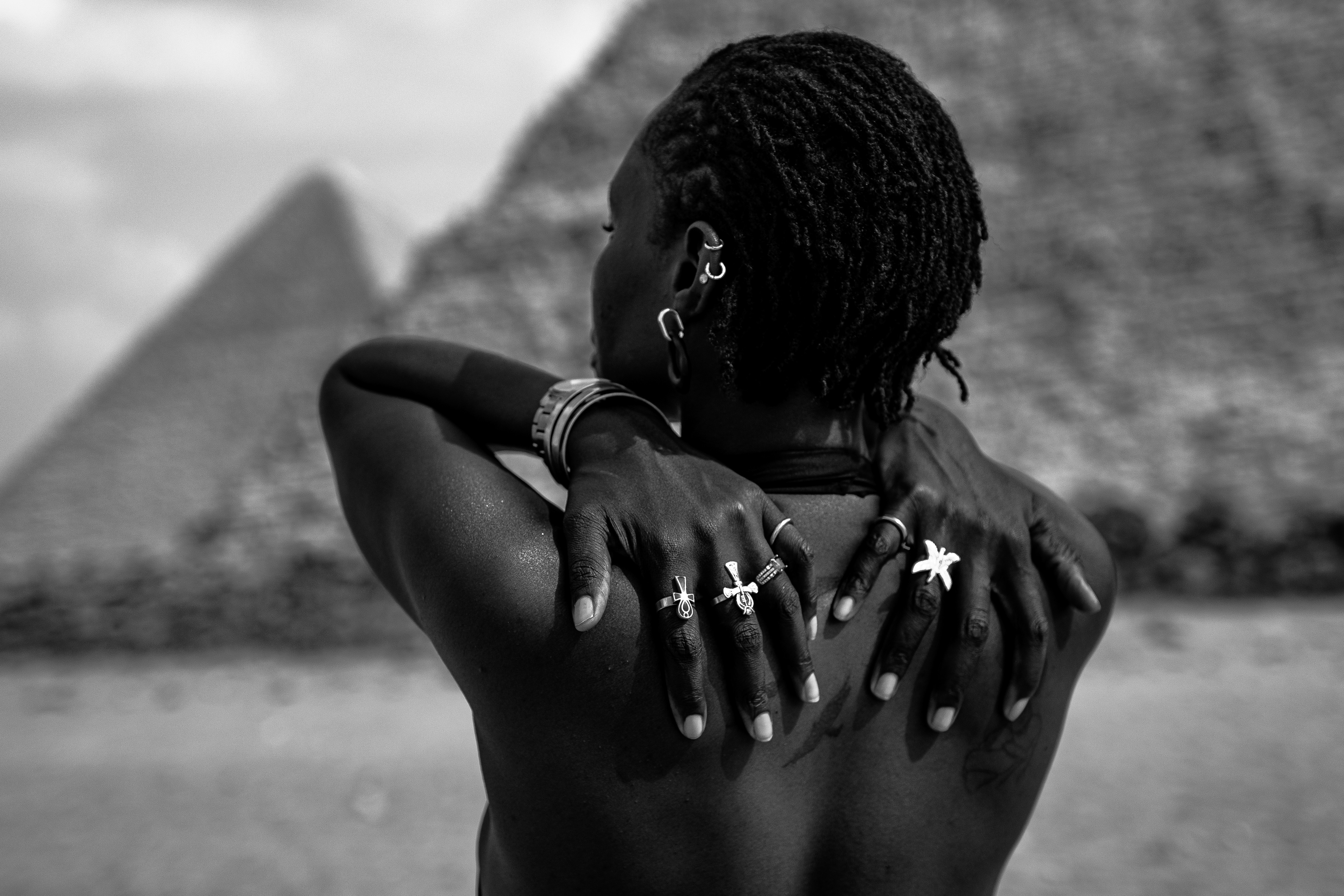 A woman standing in front of a pyramid