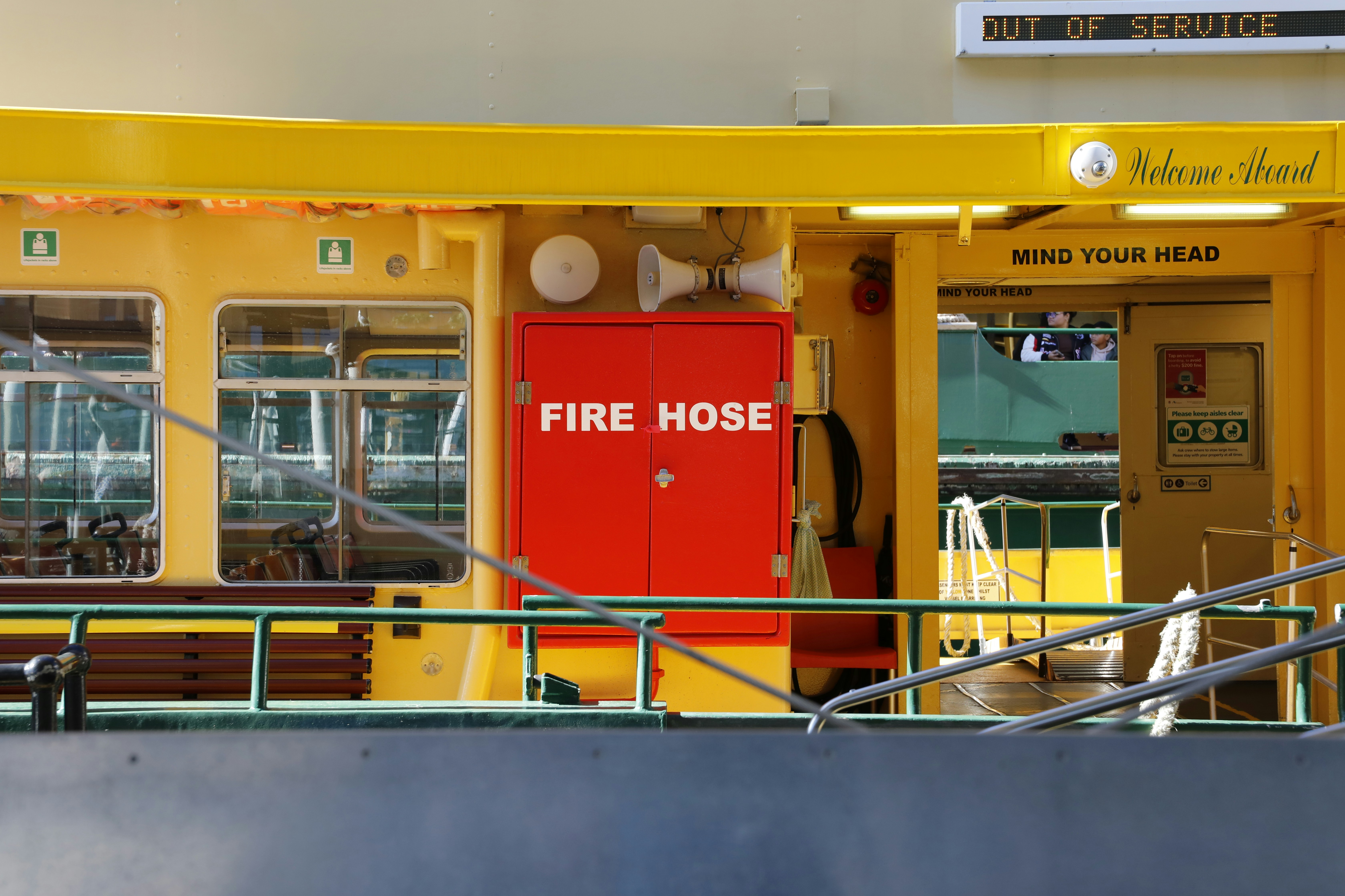 A yellow fire house with a red door